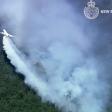 A DC-10 is dropping an alternative to retardant on wildfires in Australia