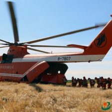 Armed forest officers and soldiers in China work with Mi-26 helicopter